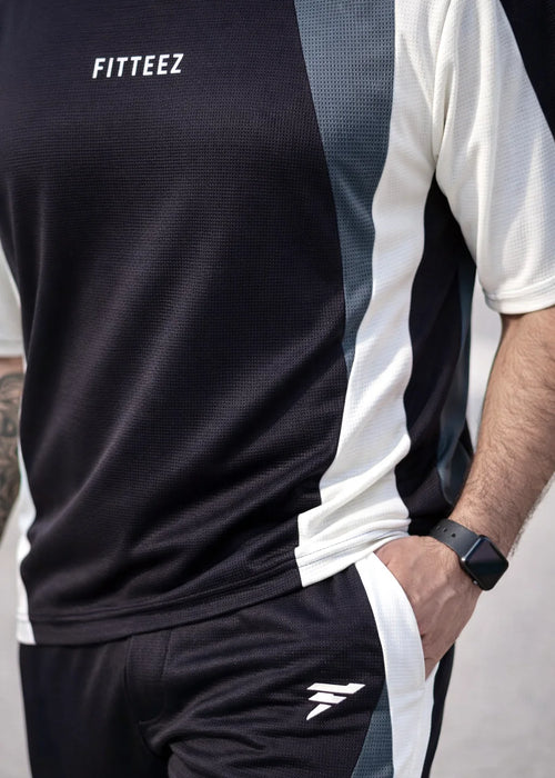 A short-sleeved crewneck t-shirt featuring a color-blocked panel design in black,