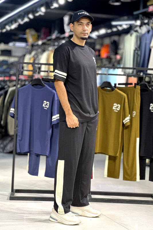 A short-sleeved crewneck t-shirt featuring a color-blocked panel design in black,