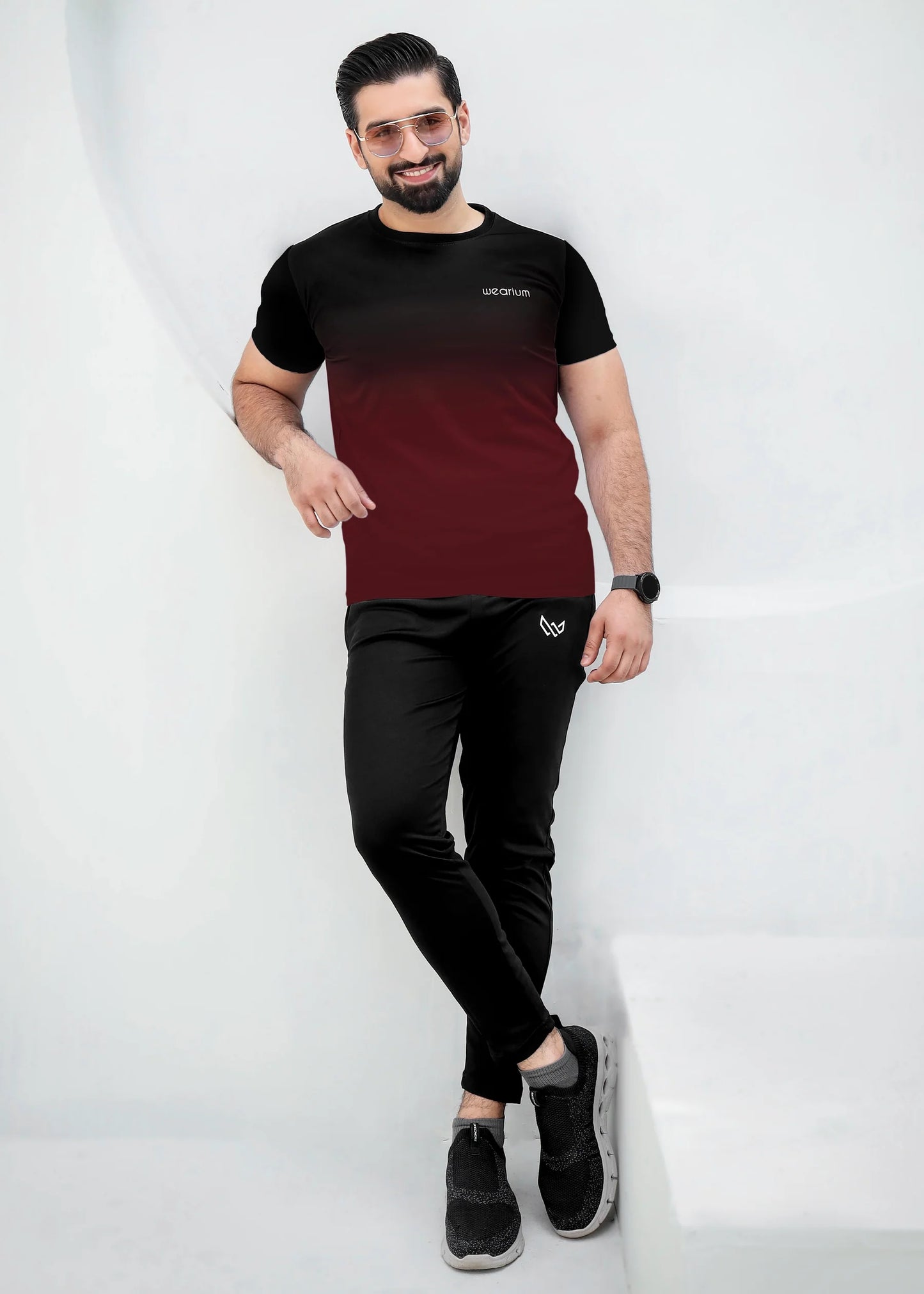Top: A short-sleeved, crewneck t-shirt featuring a gradient (ombré) design that